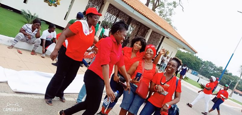 Women in red T-shirts at an outdoor event