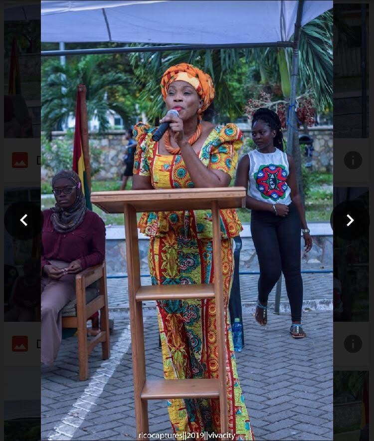 A woman speaking at a podium at an outdoor event