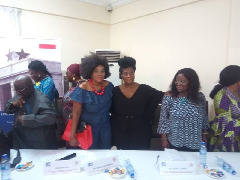 Women posing together at a conference table
