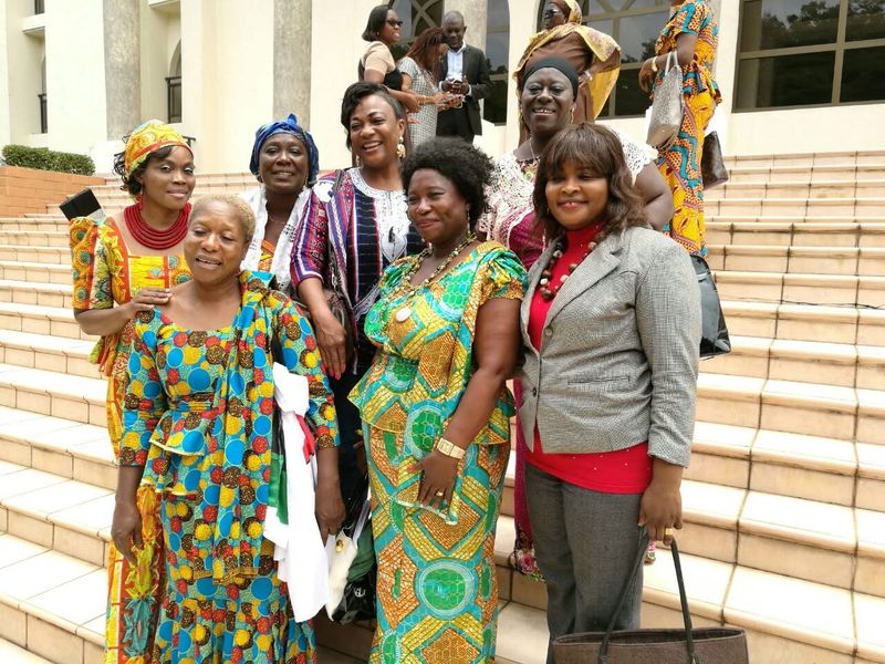 Women posing together on the steps of a building