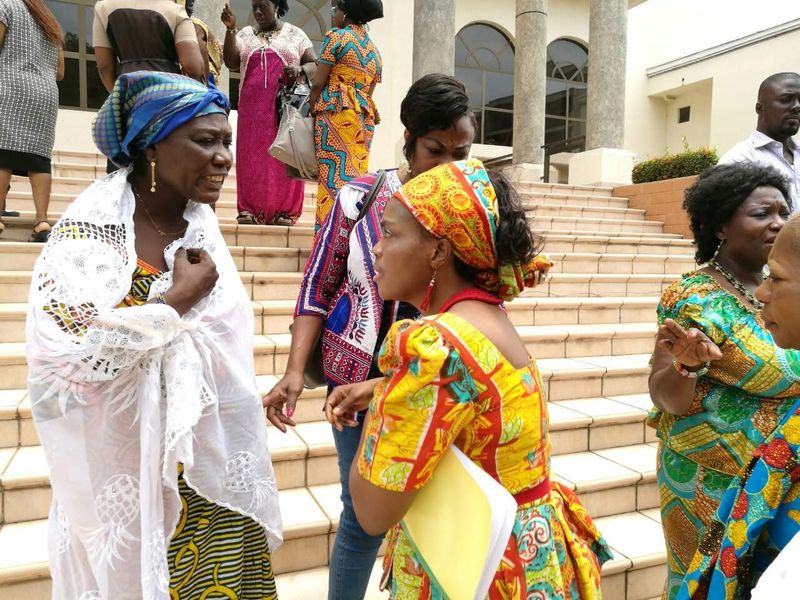 Participants mingling on the steps of a building