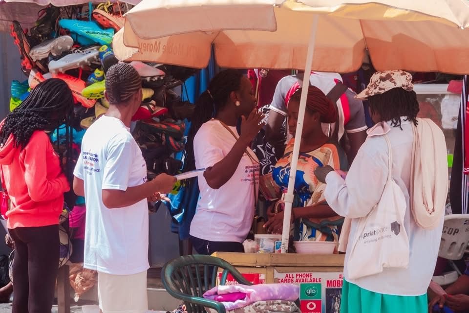 Speaking with traders at a shoe stall